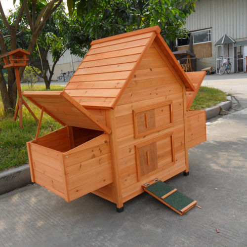 Side view of hen house with nesting box lids open, and ramp access