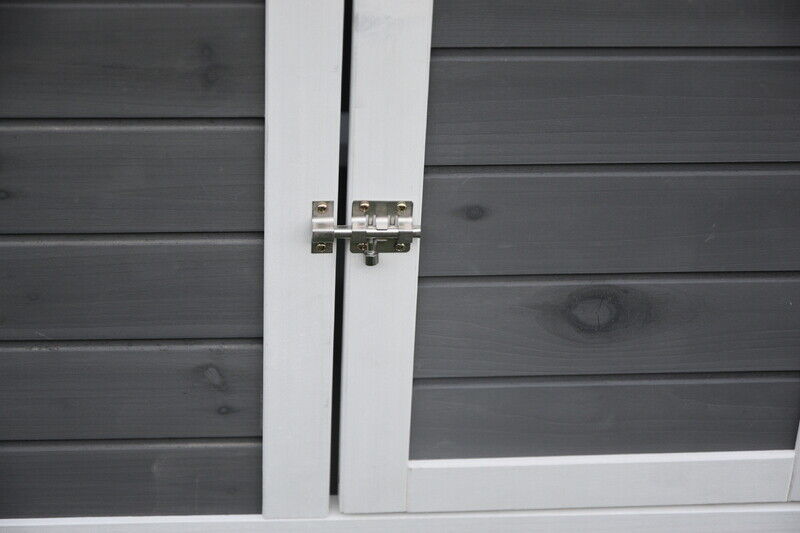 Close-up view of lock on panel of portable chicken coop.
