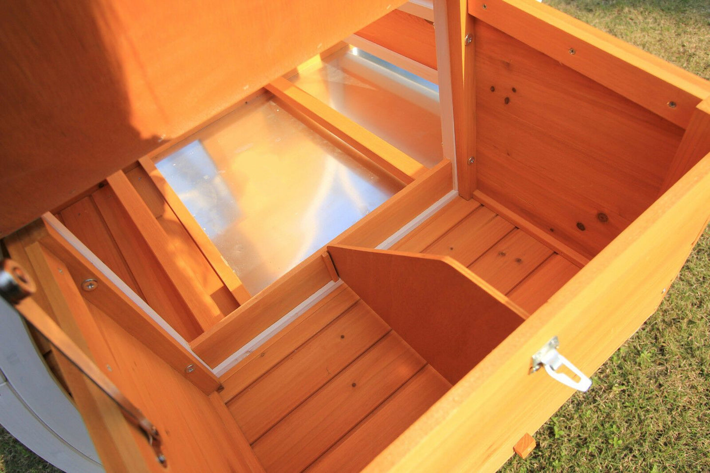 Interior view of flat pack chicken coop showing built-in slide-out tray for easy cleaning.