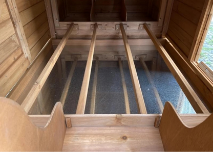 Interior of the coop, showing roosting poles and nesting boxes.