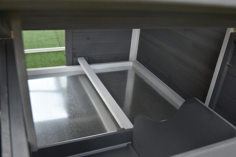 Interior roosting pole positioned over galvanised tray to collect droppings.