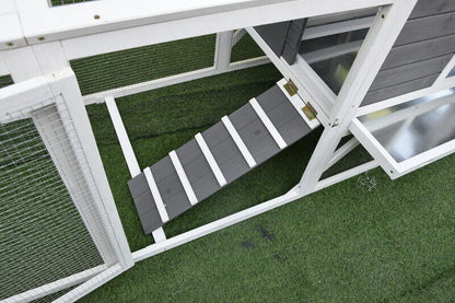 Slatted ramp with non-slip wooden slats, leading from the run to the coop.
